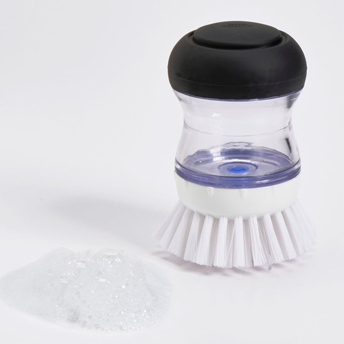 Scrubbing brush with soap dispenser